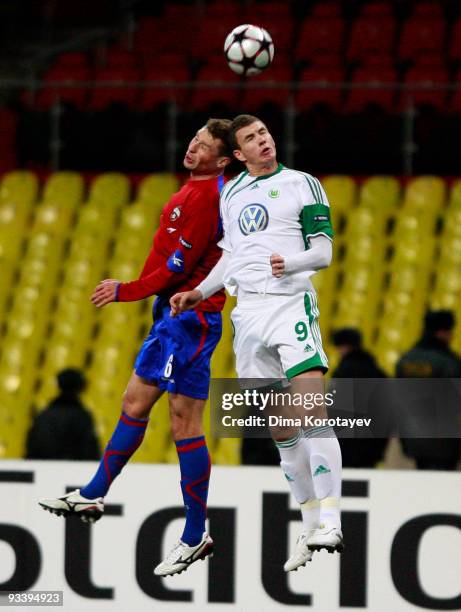 Aleksei Berezutski of CSKA Moscow fights for the ball with Edin Dzeko of VfL Wolfsburg during the UEFA Champions League group B match between CSKA...