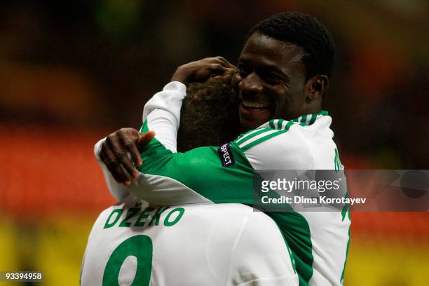 Edin Dzeko of VfL Wolfsburg celebrates with team mate Obafemi Martins after scoring the first goal during the UEFA Champions League group B match...