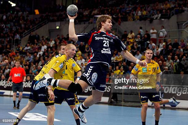 Jacob Heinl of Flensburg-Handewitt is challenged by Karol Bielecki, Oliver Roggisch and Bjarte Myrhol of Rhein-Neckar Loewen during the Toyota...