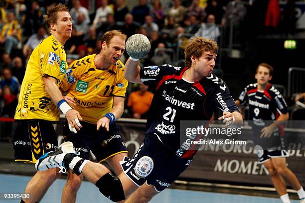 Jacob Heinl of Flensburg-Handewitt is challenged by Olufur Stefansson and Oliver Roggisch of Rhein-Neckar Loewen during the Toyota Handball...