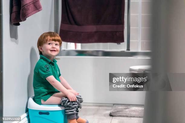 happy cute redhead little boy potty training - potty training stock pictures, royalty-free photos & images