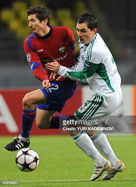 Evgeni Aldonin of CSKA Moskva vies with Marcel Schaefer of WfL Wolfsburg during the Champions League Group B football match in Moscow on November 25,...