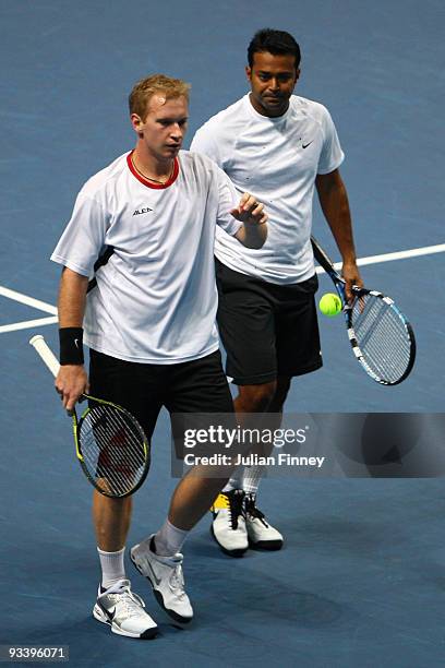 Lukas Dlouhy of Czech Republic walks next to Leander Paes of India during their men's doubles first round match against Bob Bryan of USA and Mike...