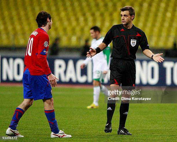 Alan Dzagoev of CSKA Moscow talks to referee Nicola Rizzoti during the UEFA Champions League group B match between CSKA Moscow and VfL Wolfsburg at...