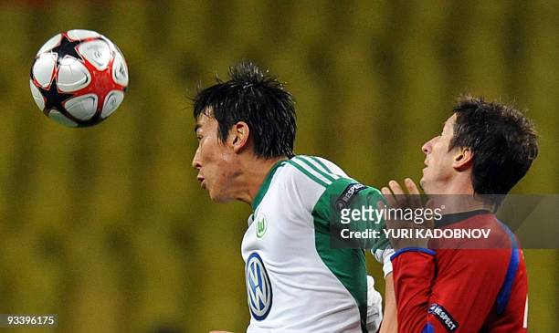Moscow's Evgeny Aldonin vies with WfL Wolfsburg's Makoto Hasebe during their UEFA Champions League Group B football match on November 25, 2009 in...