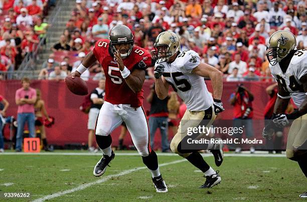 Quarterback Josh Freeman of the Tampa Bay Buccaneers scrambles and is chased by Scott Fujita of the New Orleans Saints during a NFL game on November...