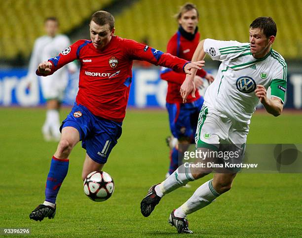 Pavel Mamaev of CSKA Moscow fights for the ball with Alexander Madlung of VfL Wolfsburg during the UEFA Champions League group B match between CSKA...