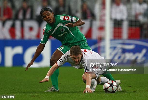 Jhon Jairo Culma of Haifa challenges Bastian Schweinsteiger of Bayern Muenchen during the UEFA Champions League Group A match between FC Bayern...