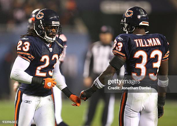 Devin Hester of the Chicago Bears touches hands with Charles Tillman as he runs off the field at the end of a game against the Philadelphia Eagles at...