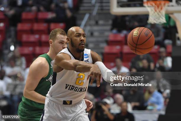 Jevon Carter of the West Virginia Mountaineers makes a pass as he plays against the Marshall Thundering Herd in the second half during the second...