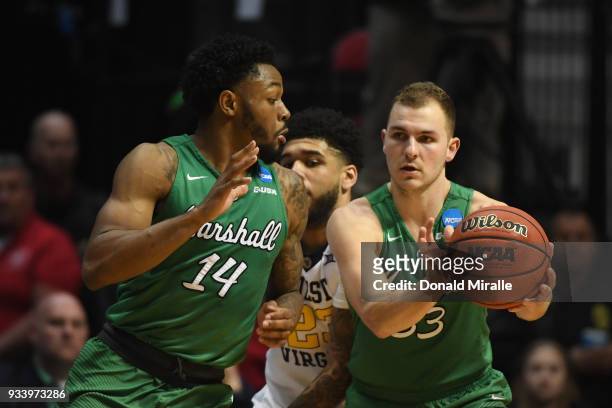 Jon Elmore passes to C.J. Burks of the Marshall Thundering Herd as they take on the West Virginia Mountaineers in the second half during the second...