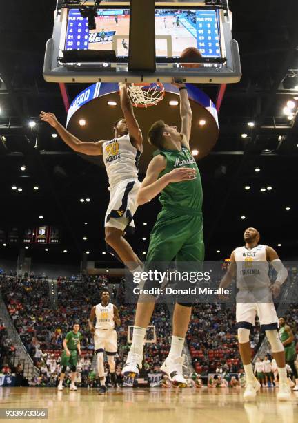 Ajdin Penava of the Marshall Thundering Herd shoots against Sagaba Konate of the West Virginia Mountaineers in the first half during the second round...