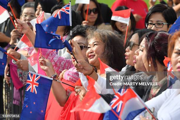 Supporters wave New Zealand and Indonesian flags outside the parliament as Indonesia's President Joko Widodo meets with New Zealand's Prime Minister...