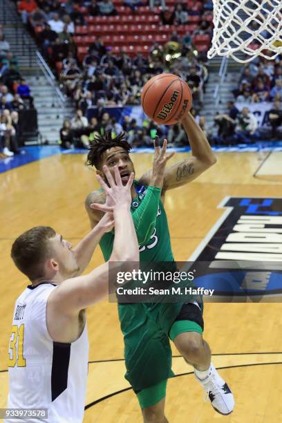 Rondale Watson of the Marshall Thundering Herd shoots against Logan Routt of the West Virginia Mountaineers in the first half during the second round...