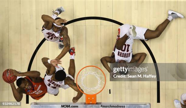 Aamir Simms of the Clemson Tigers shoots against Malik Dunbar of the Auburn Tigers as Davion Mitchell of the Auburn Tigers is seen on the ground...