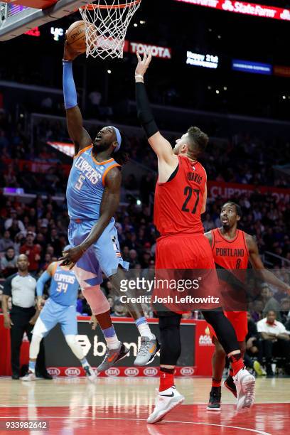 Montrezl Harrell of the LA Clippers shoots the layup against Jusuf Nurkic of the Portland Trail Blazers at the Staples Center on March 18, 2018 in...