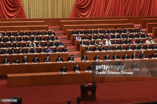 Chinese President Xi Jinping , with other officials, cast his vote during the seventh plenary session of the 13th National People's Congress at the...