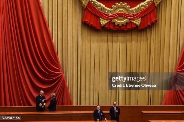 Delegates talk during the break after the vote during the seventh plenary session of the 13th National People's Congress at the Great Hall of the...