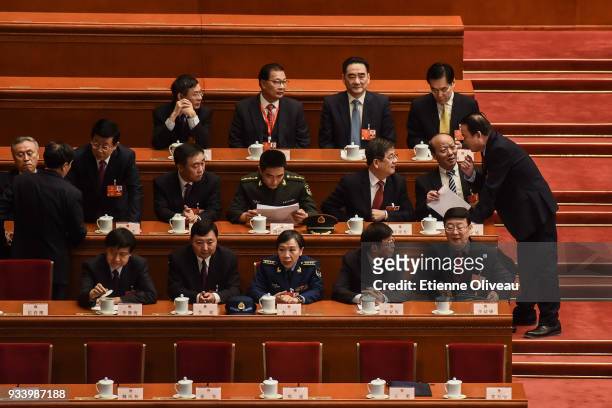 Delegates talk before the seventh plenary session of the 13th National People's Congress at the Great Hall of the People on March 19, 2018 in...