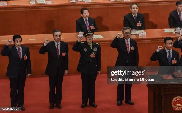 Newly elected state councilors Zhao Kezhi , Wang Yi and Wei Fenghe, Vice Premiers Hu Chunhua and Han Zheng , swear an oath during the seventh plenary...