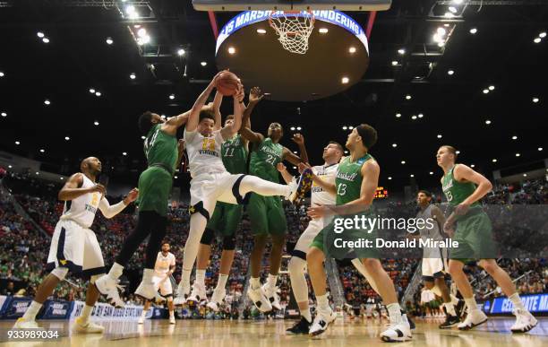 Teddy Allen of the West Virginia Mountaineers rebounds against C.J. Burks, Ajdin Penava and Darius George of the Marshall Thundering Herd in the...
