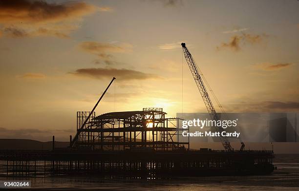 The sun sets behind the new steel framework of Weston-Super-Mare's Grand Pier on November 25, 2009 in Weston-Super-Mare, England. Although the recent...