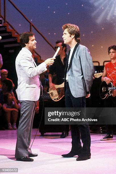 Host Dick Clark interviews Huey Lewis who performs "Heart of Rock 'n' Roll" on American Bandstand .,