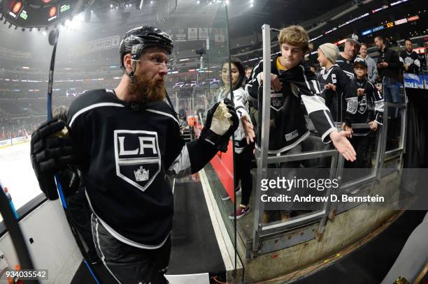 Jake Muzzin of the Los Angeles Kings slaps hands with a fan before a game against the Detroit Red Wings at STAPLES Center on March 15, 2018 in Los...