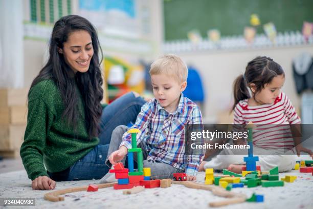 building together - baby sitter stock pictures, royalty-free photos & images