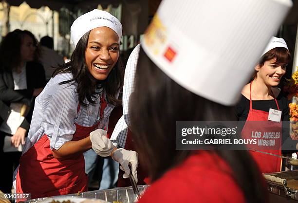 Actress Zoe Saldana serves a Thanksgiving lunch for the homeless in downtown Los Angeles, California on November 25, 2009. Kirk Douglas and his wife...