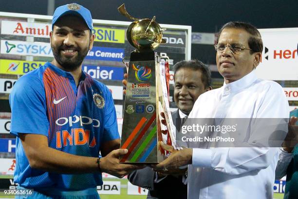Indian cricket captain Rohit Sharma receives the NIDAHAS Trophy by Sri Lankan president Maithripala Sirisena after winning the final Twenty-20...