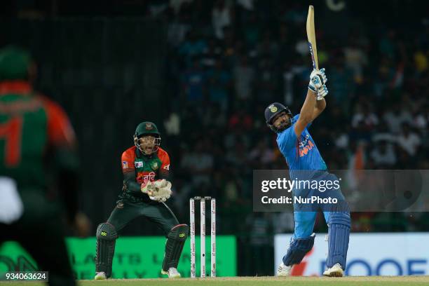 Indian cricket captain Rohit Sharma plays a shot during the final Twenty-20 cricket match of NIDAHAS Trophy between Bangladesh and India at R...