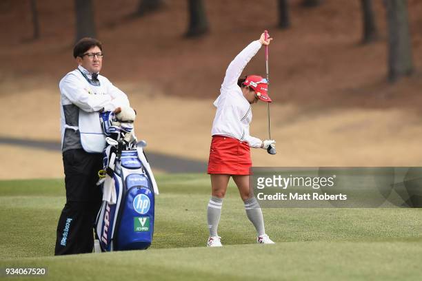 Chie Arimura of Japan prepares to play her second shot on the 1st hole during the final round of the T-Point Ladies Golf Tournament at the Ibaraki...