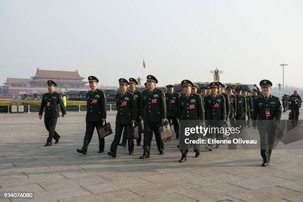 Military Delegates walk on Tiananmen Square before the seventh plenary session of the 13th National People's Congress at the Great Hall of the People...