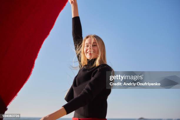 young woman running along ocean shore - blonde yoga foto e immagini stock