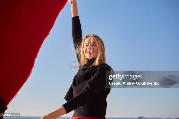 young woman running along ocean shore - lisbon people stock pictures, royalty-free photos & images