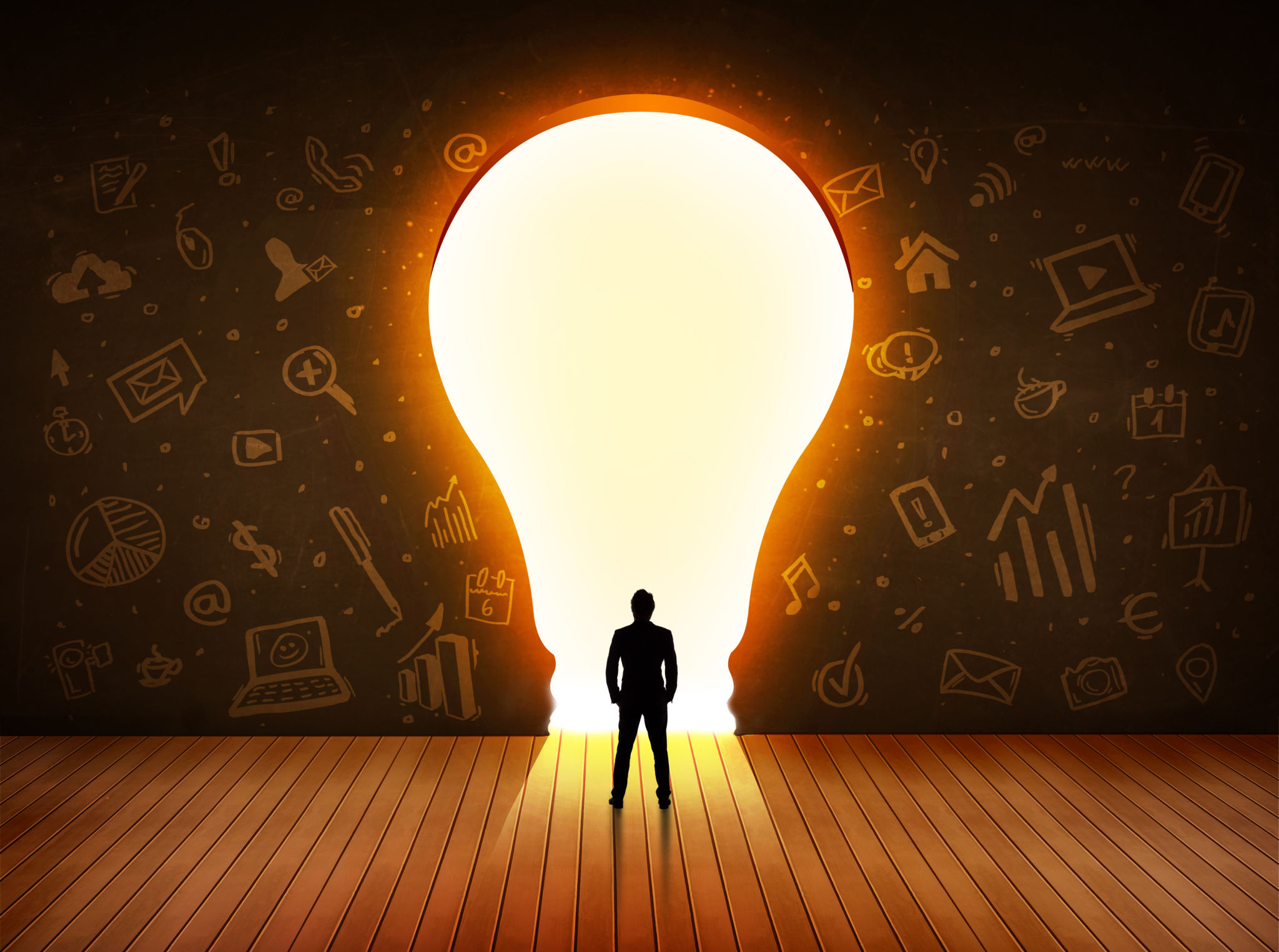 Business man looking at bright light bulb in the wall Business man looking at bright light bulb in the wall