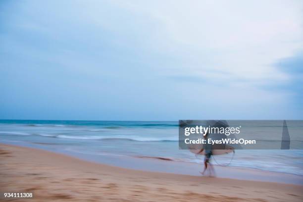 Local people and tourists visit Hikkaduwa Beach in the south-ouest coast for sightseeing, surfing, sunbathing and shopping on March 02, 2014 in...