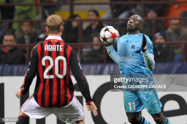 Olympique Marseille's Senegalese forward and captain Mamadou Niang controls the ball in front of A.C. Milan's midfielder Ignazio Abate during their...