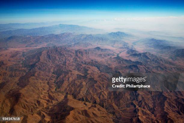 aerial panoramic view at mountain range from airplane above afghanistan - afghanistan aerial stock pictures, royalty-free photos & images