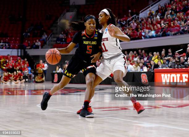 Maryland Terrapins guard Kaila Charles tries to get past North Carolina State Wolfpack Kiara Leslie , a former Terp, in the first half of the NCAA...