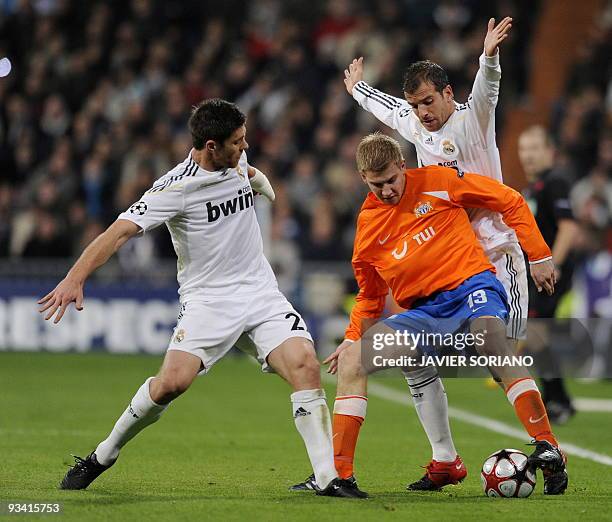 Real Madrid's Dutch midfielder Rafael van der Vaart and Real Madrid's midfielder Xabi Alonso fight for the ball with Zurich's defender Florian Stahel...