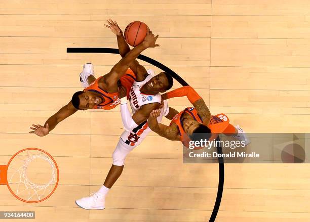 Jared Harper of the Auburn Tigers is defended by Shelton Mitchell and Aamir Simms of the Clemson Tigers during the second round of the 2018 NCAA...