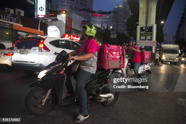 Couriers for Foodpanda, a meal-delivery service operated by Delivery Hero AG, make their way through traffic in Bangkok, Thailand, on Friday, March...
