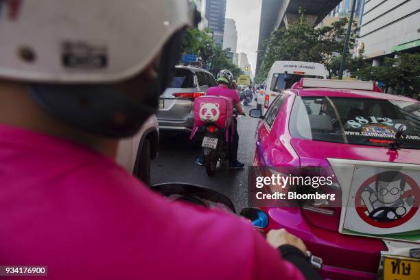 Couriers for Foodpanda, a meal-delivery service operated by Delivery Hero AG, make their way through traffic in Bangkok, Thailand, on Friday, March...