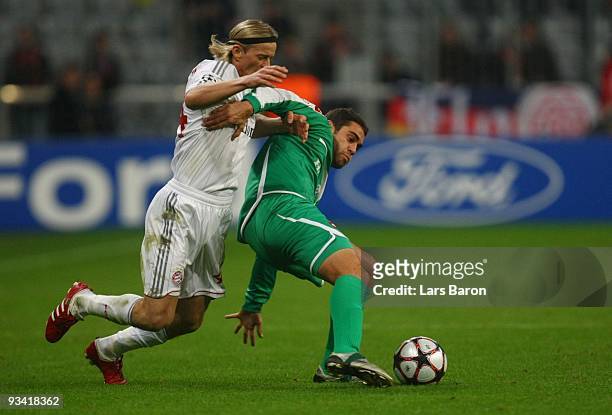 Anatoliy Tymoshchuk of Bayern and Shlomi Arbeitman of Haifa battle for the ball during the UEFA Champions League Group A match between FC Bayern...