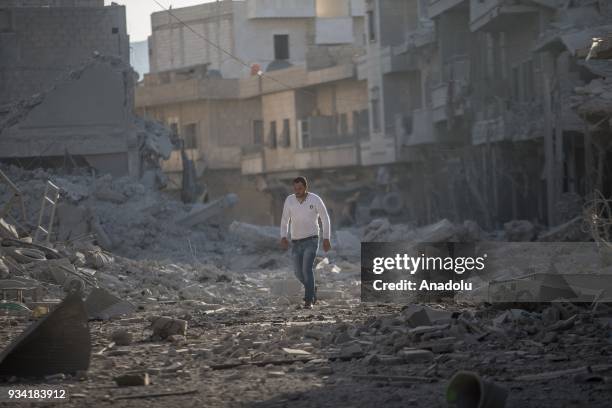 Damaged buildings are seen after a bomb planted by YPG/PKK terrorists exploded in a four-story building in Afrin town center in Syria on March 19,...