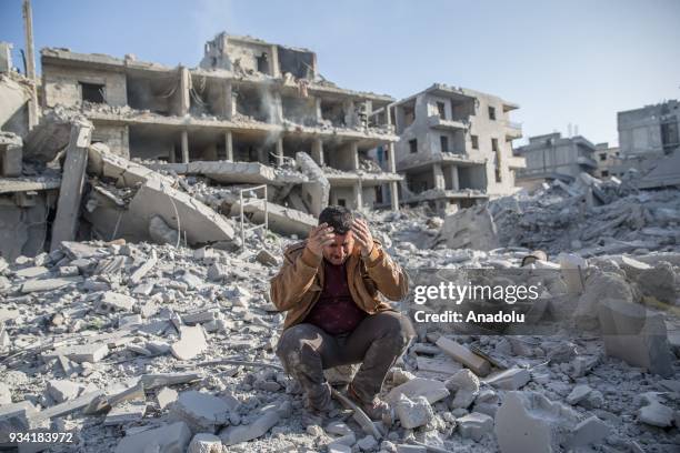 Damaged buildings are seen after a bomb planted by YPG/PKK terrorists exploded in a four-story building in Afrin town center in Syria on March 19,...