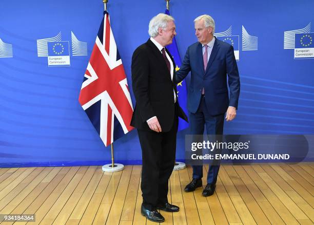 British Brexit minister David Davis and EU chief negotiator Michel Barnier meet at the European Commission in Brussels on March 19, 2018. / AFP PHOTO...