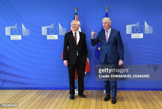 British Brexit minister David Davis and EU chief negotiator Michel Barnier meet at the European Commission in Brussels on March 19, 2018. / AFP PHOTO...